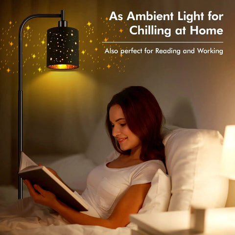 Industrial Floor Lamp With Adjustable Three Light Tree Stand illuminating a woman reading in bed, black metal with gold interior.