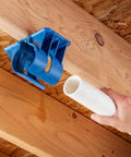 Premium Rockler Dust Right 4 Inch Hose Cradles holding a white PVC pipe, demonstrating heavy duty ABS support for workshop ventilation.