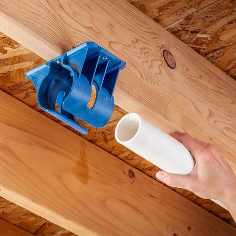 Premium Rockler Dust Right 4 Inch Hose Cradles holding a white PVC pipe, demonstrating heavy duty ABS support for workshop ventilation.