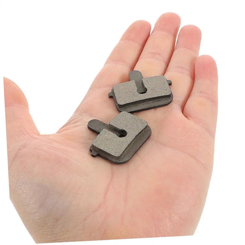 2 Pairs Bike Disc Brake Pads For Hydraulic And Mechanical Disc Brakes Replacement Pads For Mountain Bikes And Electric Scooters Quiet High Braking Power Wide Compatibility And Smooth Stopping On Rough Trails displayed on a hand