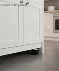 Furniture Leveling Feet Adjustable Height Set For Cabinets And Appliances with black plastic base in kitchen setup.