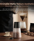 Keep Your Morning Brew Fresh As Heck With This Game Changing Smart Vacuum Sealed Coffee Canister Featuring Digital Pressure Gauge Rechargeable Design And Airtight Glass Storage on a wooden table.