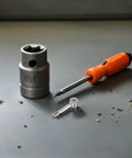 No Sweat Pro Level Knock Down Furniture Hardware Kit With Alloy Cam Bolt Dowels And Flat Back Cam Locks tools laid on a gray surface.