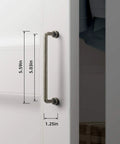 Close-up of Six Pack 5 Inch Center To Center Antique Silver Cabinet Bar Pulls on white cabinet door with dimensions shown.
