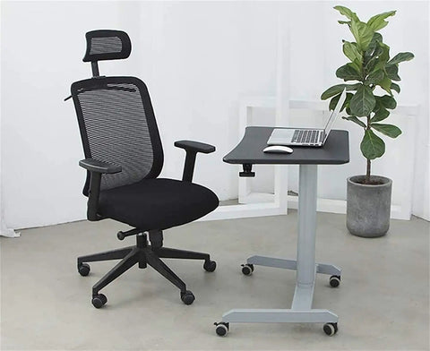Height Adjustable Mobile Standing Desk With Smooth Roll Wheels Built Tough Rust Resistant Steel Laptop Lectern Workstation Spacious Matte Black Surface No Extra Fluff Office Or Home Setup beside an ergonomic black office chair.