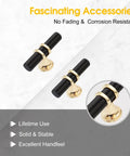 Close-up view of two black and gold T bar knobs from 10 Pack Black And Gold Cabinet Pulls T Bar Knobs For Kitchen And Bathroom Cupboards No Fuss Single Hole Handles For Dresser Drawers With Easy Install Screws Included on marble surface.