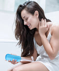 Woman using On The Go Bidet For Travel Large 450ml Capacity Handheld Blue No Batteries Needed Eco Friendly Personal Toilet Cleaner