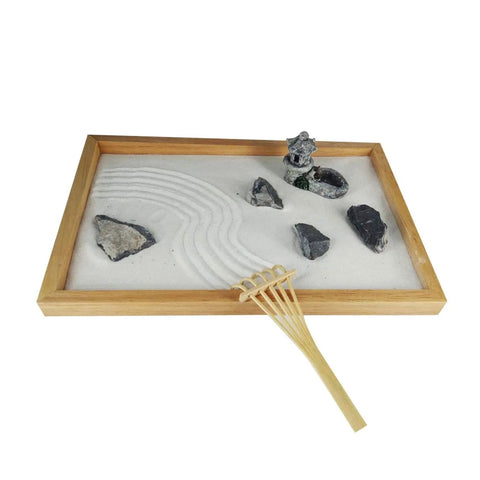 Mini Zen Garden Rake Tools Set With 24 Pieces, Bamboo Sand Rakes For Desk creating sand patterns in a wooden tray.