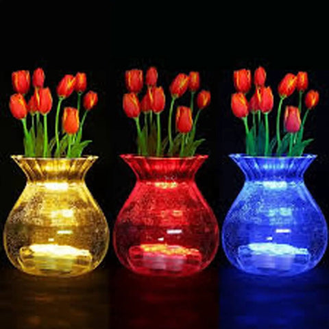 Amber LED Floral Tea Lights Submersible in glass vases with red tulips at wedding party