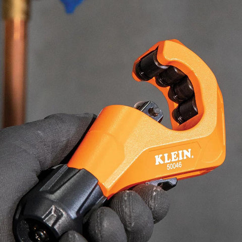 Tubing cutter Klein 50046 Constant Swing in orange, held by gloved hand