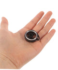 Vintage Mechanical Alarm Clock Repair Kit With Precision Steel Parts And Winding Key in hand for timepiece maintenance.