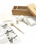 All In One Blade Cleaning And Maintenance Kit For Japanese Sword Care laid out with choji oil, brass hammer, and rice paper.