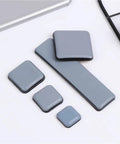 Heavy Duty Furniture Sliders Self Adhesive Floor Protectors Move Heavy Gear Without Breaking A Sweat 100 Pack gray glide pads displayed on a surface.
