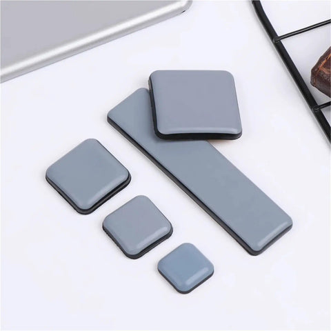 Heavy Duty Furniture Sliders Self Adhesive Floor Protectors Move Heavy Gear Without Breaking A Sweat 100 Pack gray glide pads displayed on a surface.
