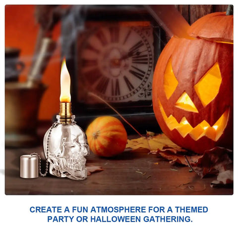 Lit Skeleton Skull Glass Table Torch For Outdoor Patio Decor beside glowing pumpkin for Halloween accents