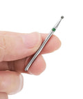 Close-up of a hand holding a 2mm ball head from the Three Piece Diamond Grinding Bit Set With 2mm Ball, 2mm Tapered, And 2.3mm Oval Heads, 2.35mm Shank, Grits 100 120 200 230 120 140, Pro Grade Rotary Tool Bits For Ceramic Glass Nails Sanding And Polishing.