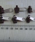 Six Piece Zipper Repair Kit With Replacement Sliders Teeth Top And Bottom Stops Insertion Pins For Jackets Bags And Pants Fix Any Zipper Fast And Easy next to ruler