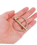 Heavy Duty Lynch Pin Kit 8Pc Assortment With Ring Locking Pins For Farm Tractors Trailers And Machinery Accessories Dirt And Wear Resistant Durable Fasteners. single metal lynch pin in hand