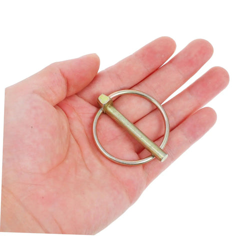 Heavy Duty Lynch Pin Kit 8Pc Assortment With Ring Locking Pins For Farm Tractors Trailers And Machinery Accessories Dirt And Wear Resistant Durable Fasteners. single metal lynch pin in hand