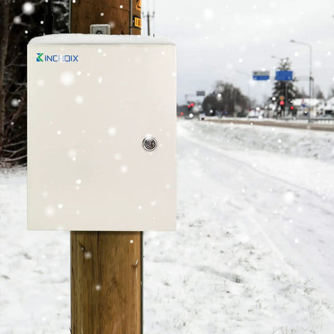 Outdoor Electrical Box 12 By 12 By 8 Inches NEMA 4X Steel Enclosure Waterproof Lockable Junction Box installed on snowy pole.