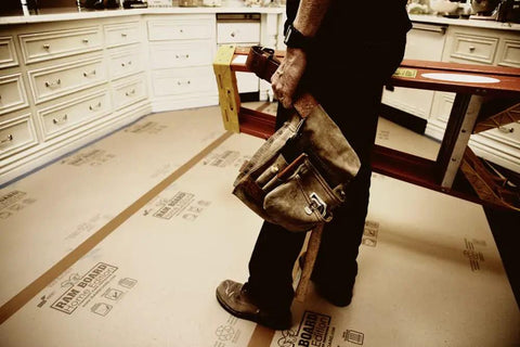 Worker using Heavy Duty Floor Protector Roll 36 Inch By 50 Feet For Painting And Remodeling Jobs Tough Temporary Floor Shield