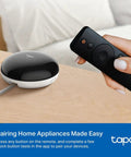 Person using remote with Smart IR And IoT Hub With Chime Universal Remote For TVs, ACs, Fans, And 18 Plus Devices, Matter Certified.