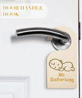 Wooden door hanger reading 'No Disturbing' on silver handle