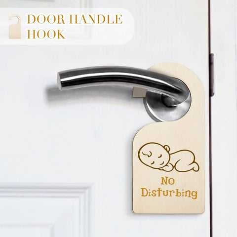 Wooden door hanger reading 'No Disturbing' on silver handle