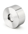 Front view of a stainless steel coil roll with concentric grooves and central hub.