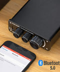 BT10A Bluetooth 5.0 Stereo Amplifier Receiver 2 Channel Class D Mini Hi Fi Integrated Amp for home passive speakers 50W x 2 shown with phone