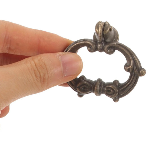 Close-up of a vintage style metal ring pull handle in hand, 4 Pack Vintage Style Metal Ring Pull Handles For Jewelry Boxes, Drawers, Cabinets, Wardrobes, And Home Furniture, Classic Single Hole Knob Set, Durable Zinc Alloy Hardware, Easy Install, Timeless Charm