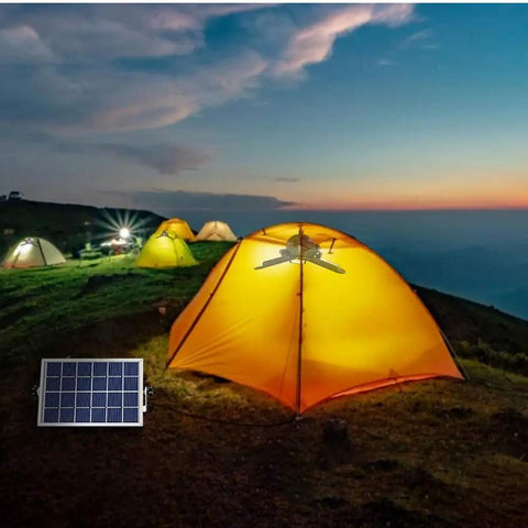Premium Solar Pendant Light With Remote Control And Sixty Leds illuminates a yellow tent in a camping setting at dusk.