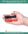 Hand holding insulated alligator clips for multimeter with 2mm probe tips, flexible boots, nickel plated safety clips.