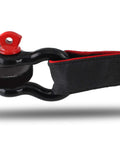 Close-up of black and red shackle connected to strap, part of 4 Pack 1/2 Inch D Ring Shackles Heavy Duty Tow Shackles With Screw Pin For Winch And Off Road Vehicle Recovery 12 Ton Break Strength Red And Black Ideal For Jeep Truck ATV UTV Recovery