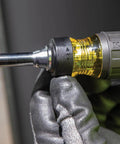 Close-up of a Ratcheting Multi-Bit Screwdriver 15-In-1 with gloved hand adjusting the ratchet mechanism and visible handle.