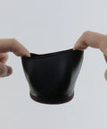 Smooth Rolling Tpe Caster Cups For Office Chairs Straight Up Floor Protectors That Block Hardwood And Carpet From Deep Scrapes Quiet Slide Wheel Stops Five Pack Durable Rubber Foot Caps shown being held, flexible black TPE material.