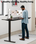 Heavy Duty Dual Motor Electric Standing Desk 71 By 32 Large Height Adjustable Sit Stand Workstation Pro Setup For Home Office Gaming And Daily Grind with dual monitors and plant.