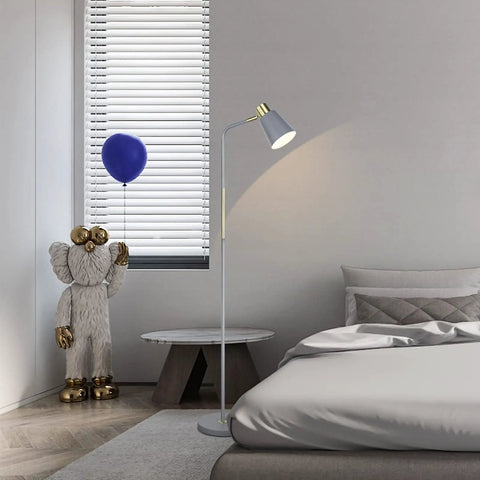 Dope Industrial Floor Lamp with Adjustable Metal Heads in bedroom next to a bed, rustic farmhouse style in grey finish, indoor task lighting.