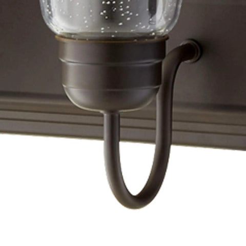 Detail of oiled bronze arm on 36-inch Transitional Five Light Vanity Fixture in Oiled Bronze with Clear and Seeded Glass