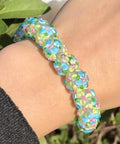 Score These Hella Rad Lampwork Glass Round Spacer Beads With Big Center Holes Perfect For DIY Jewelry Making Kicking Up Your Bracelet And Necklace Crafting Vibes Today. Colorful bracelet made of lampwork glass beads on a wrist.