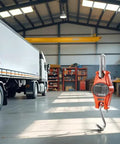 Orange Beefy Industrial Digital Scale 300 Kg 600 Lb SF-918 Heavy Duty Crane Scale hanging in a warehouse setting with a truck