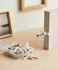 50 Pack Drywall Toggle Anchors with Carbon Steel Screws, Nylon Hollow Wall Mount Kit used in drywall installation, on desk