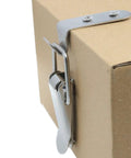Close-up of stainless steel 90 degree toggle latch installed on cardboard box, heavy duty rust resistant cabinet hardware