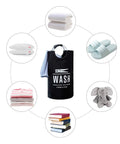 Two Pack Collapsible Laundry Hamper With Waterproof 82L Capacity Portable Foldable Laundry Basket With Rugged Aluminum Ring Handles Black, surrounded by common household items.
