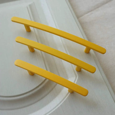 Bright Yellow Zinc Alloy Drawer Pulls For Kitchen Cabinets And Dressers With Multiple Hole Centers Like Three Inches displayed on a surface.