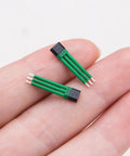 Close-up of person holding two 4601H Bipolar Latch Hall Effect Sensor For E Bike Motors With Analog Voltage Output Ultra Compact 0.7in x 0.16in