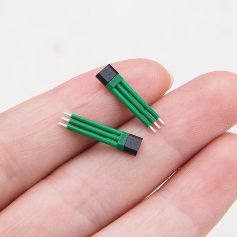 Close-up of person holding two 4601H Bipolar Latch Hall Effect Sensor For E Bike Motors With Analog Voltage Output Ultra Compact 0.7in x 0.16in