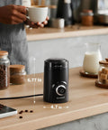 Electric Coffee Grinder With 70g Large Capacity And Visual Timing Knob For Precise Grind, black, on a wooden kitchen counter.