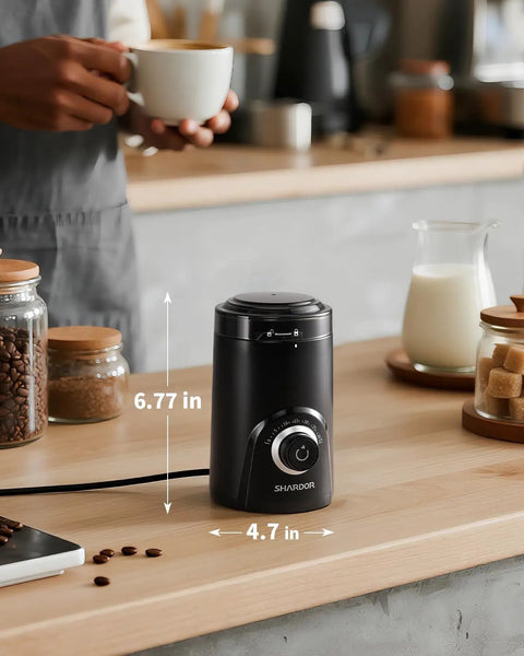 Electric Coffee Grinder With 70g Large Capacity And Visual Timing Knob For Precise Grind, black, on a wooden kitchen counter.