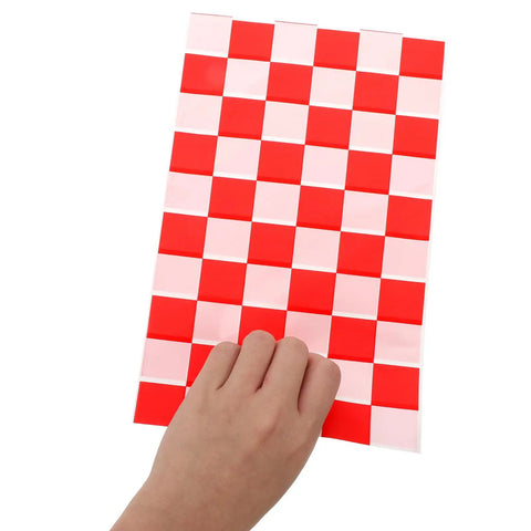 Hand holding Race Car Themed Gift Bags With Handle Pack Of 50 Portable Lightweight Plastic Candy Bags Checkered Pattern
